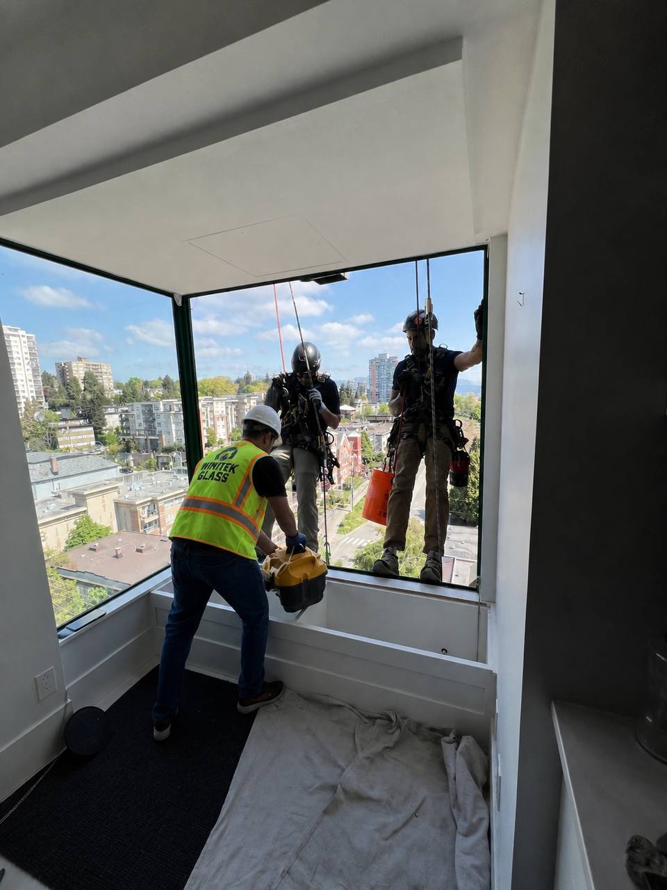 Wintek Glass certified team installing commercial window on high-rise building in Vancouver